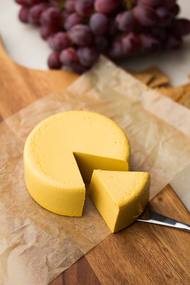 round block of cheese with a slice taken out