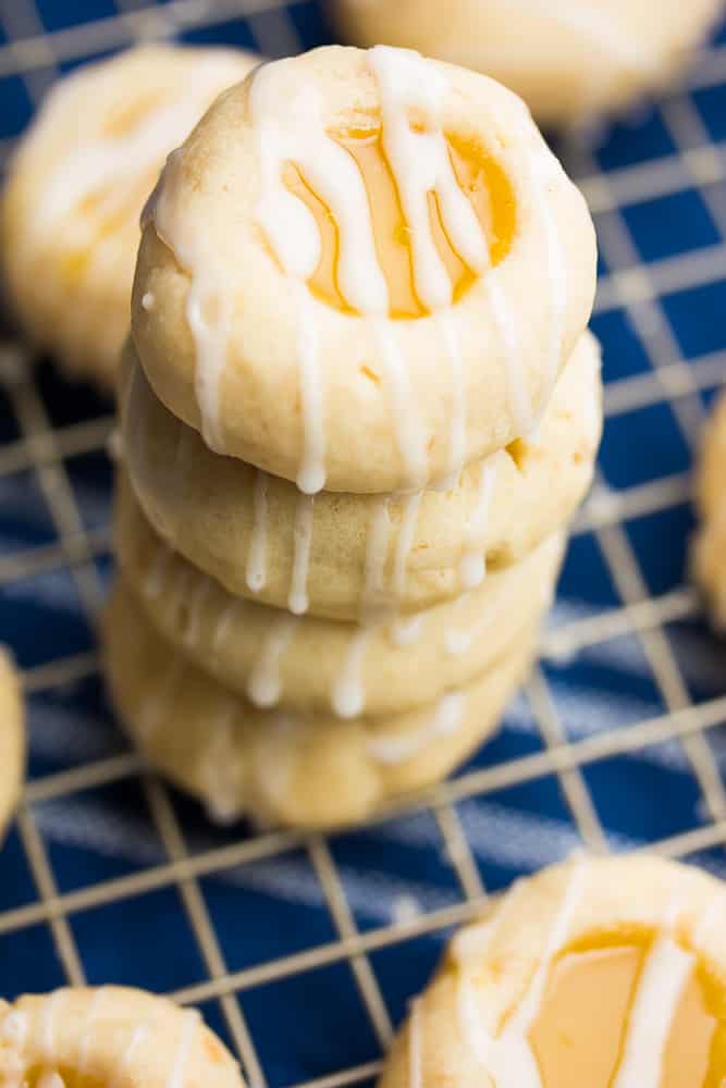 a stack of cookies on a cooling rack with a blue towel underneath