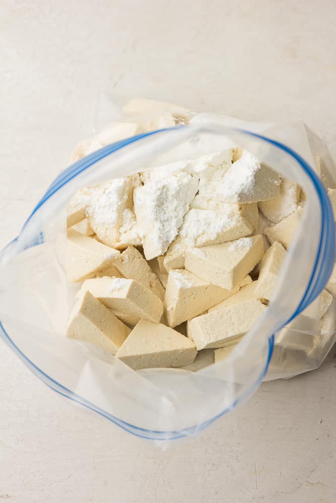 clear bag with tofu in it and cornstarch/oil