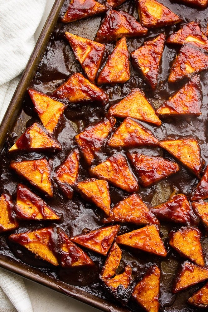 tofu covered in bbq sauce on sheet pan