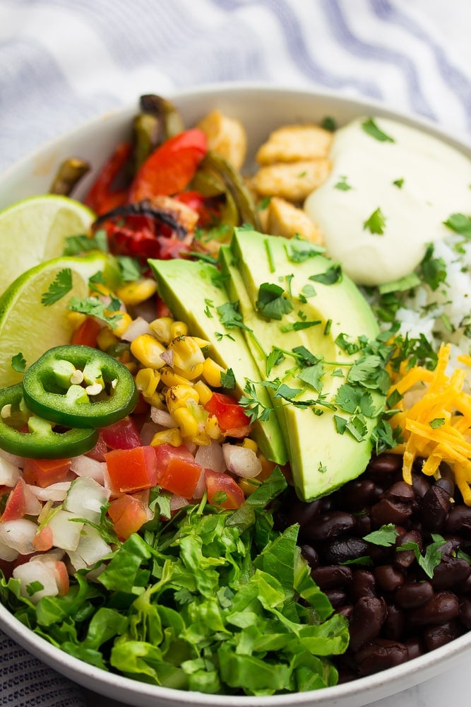 close up of vegan burrito bowl with avocado and cilantro