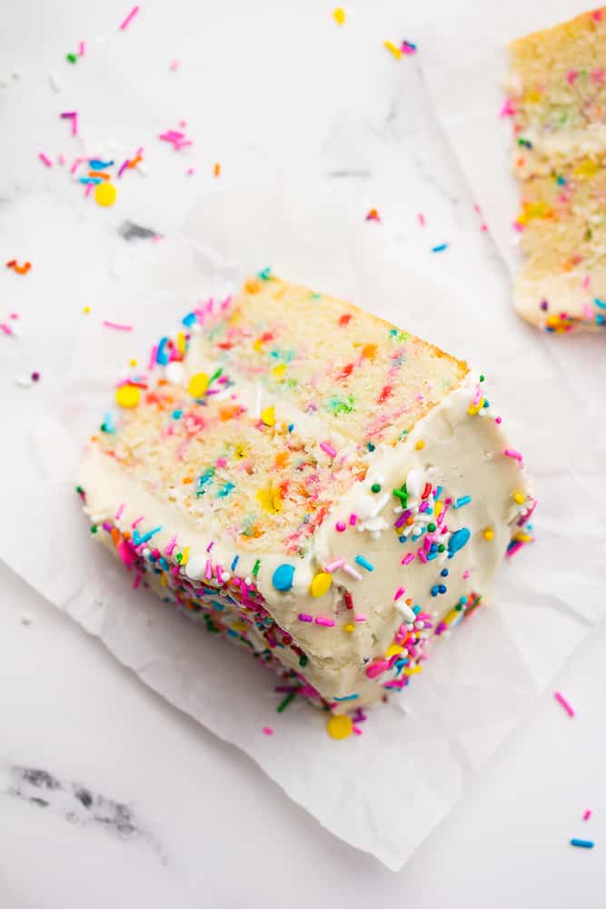 looking down on a piece of funfetti cake, white background