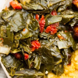 square image of greens, tomatoes in a bowl with grits