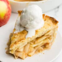 square image of apple pie with ice cream on top