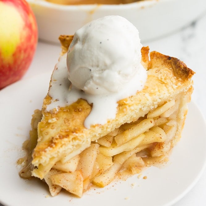 square image of apple pie with ice cream on top