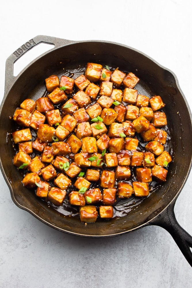 cast iron pan full of tofu in sauce