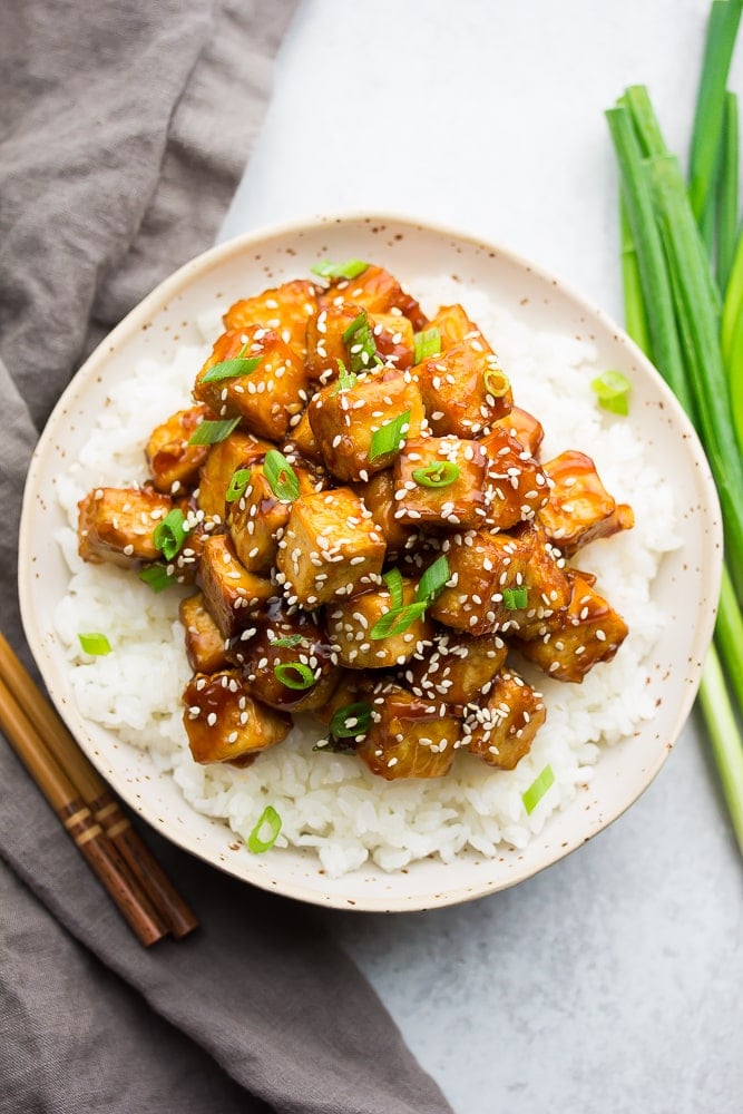 bowl with white rice and tofu with sauce and sesame seeds