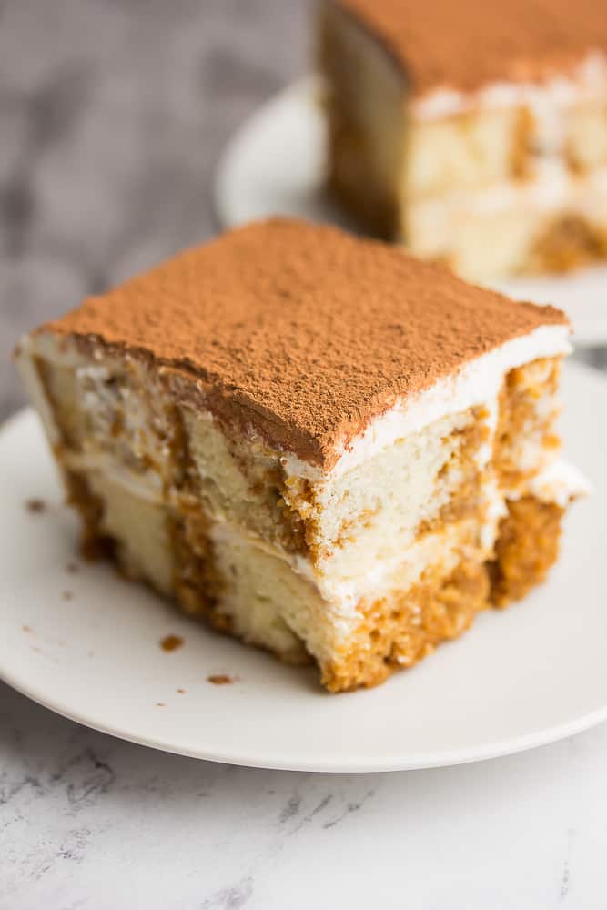 Piece of tiramisu cake on a white plate