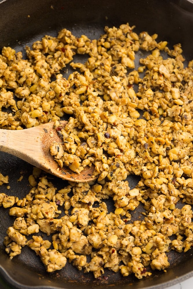 Tempeh sautéing in a cast iron skillet