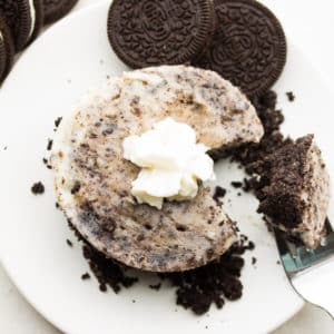 square image of a small cheesecake with oreos and whipped cream