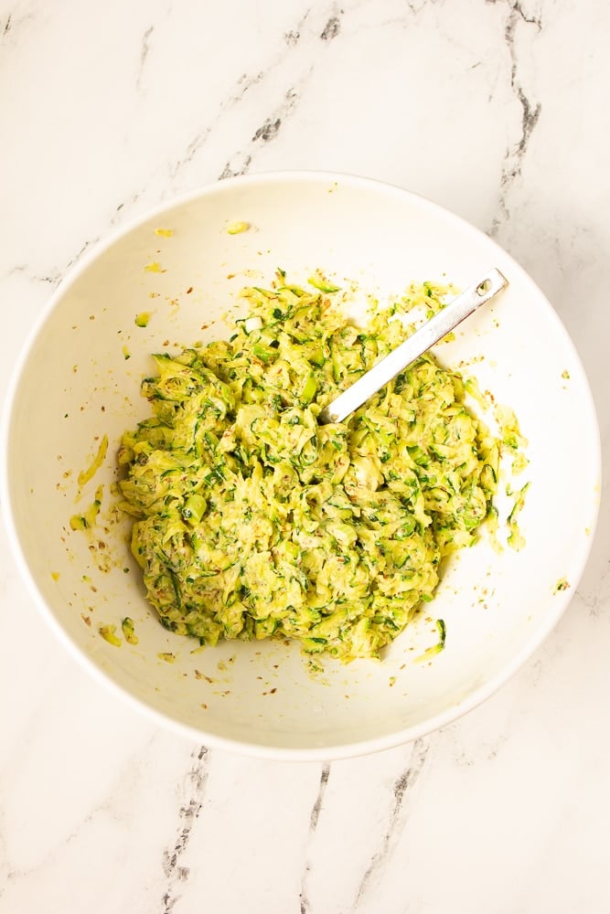 white bowl with zucchini mixture and spoon