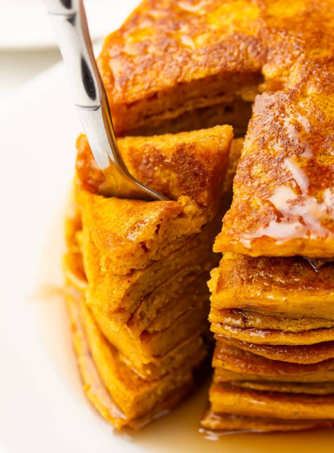 fork taking a large stack bite of pancakes