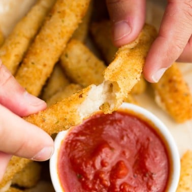 square image of fried cheese being pulled apart with hands