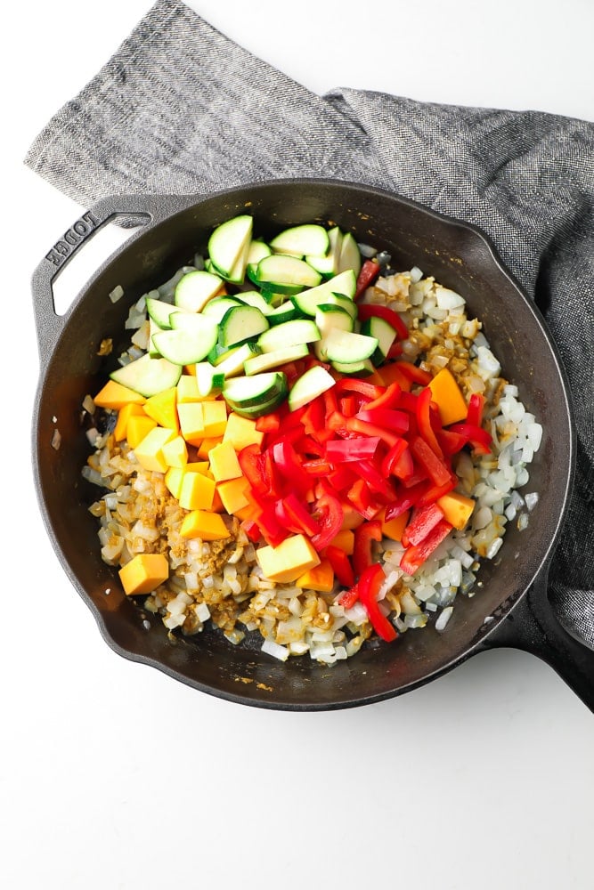 cast iron pan with vegetables in it