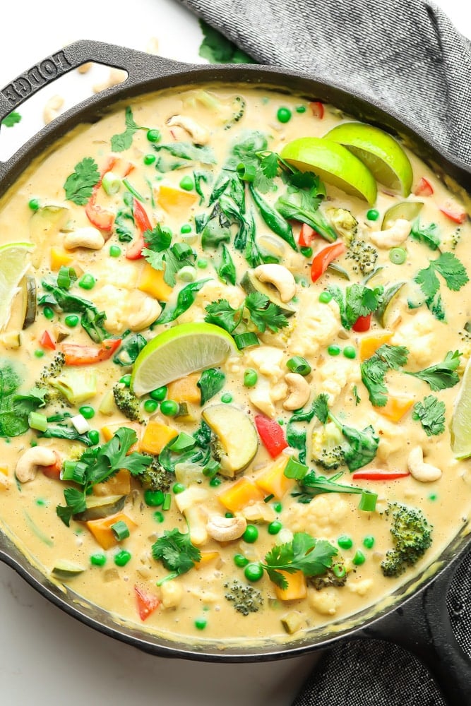 vegan thai green curry in a pan with lime slices