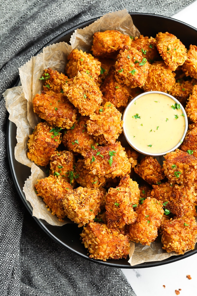 bowl of crispy nuggets with yellow sauce