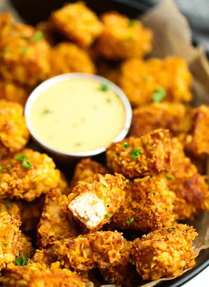 nuggets in bowl with a bite taken out of one