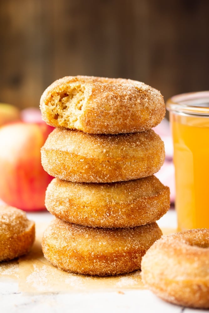 stack of donuts, one with a bite taken out