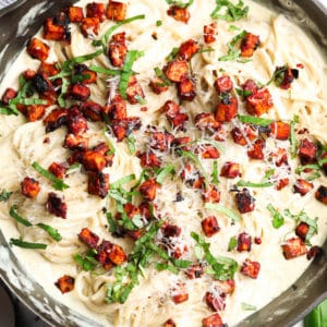 square image of a cast iron pan with pasta and tofu bacon