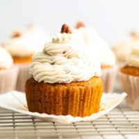square image of close up cupcake from the side with pecans on top