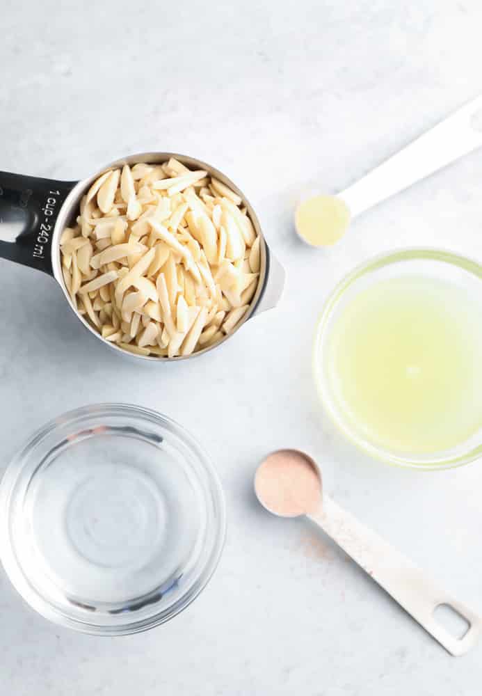 measuring cups/spoons with almonds, lemon juice and spices
