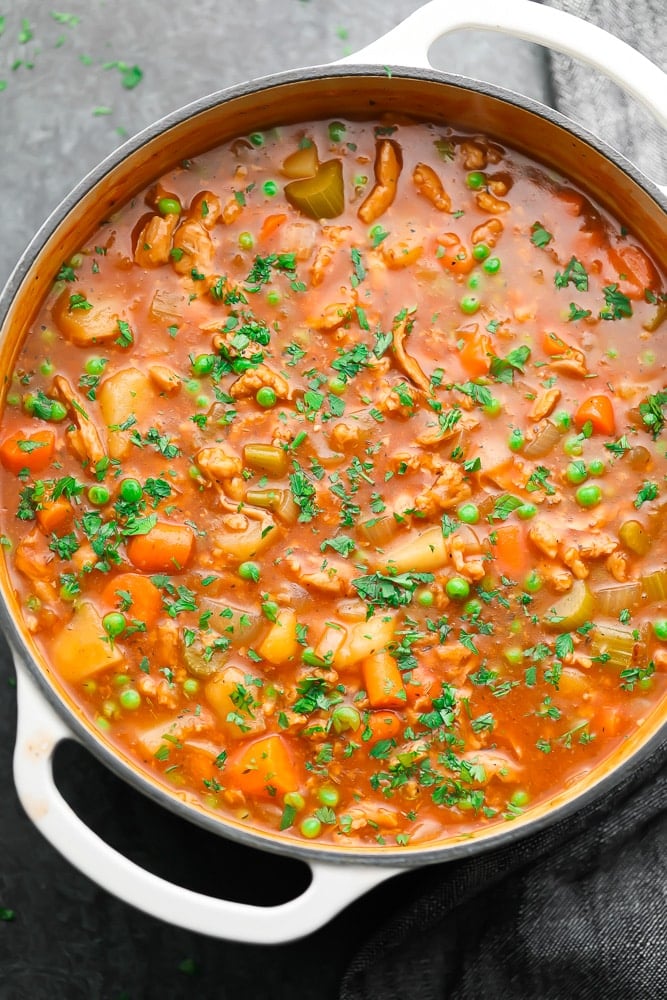 big pot of stew, black background