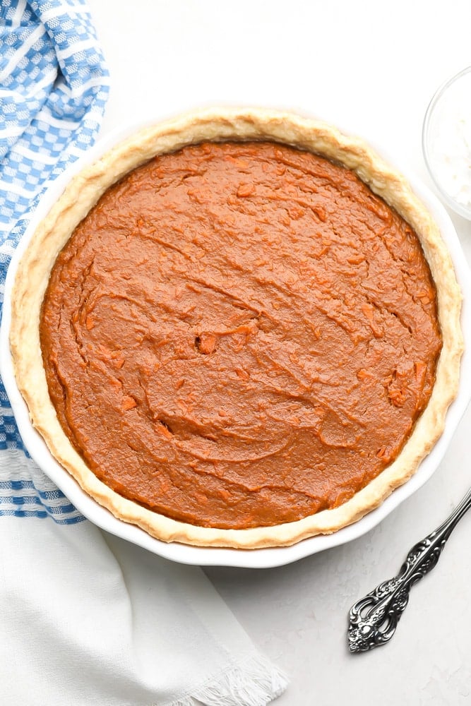 whole vegan sweet potato pie with blue towel in background