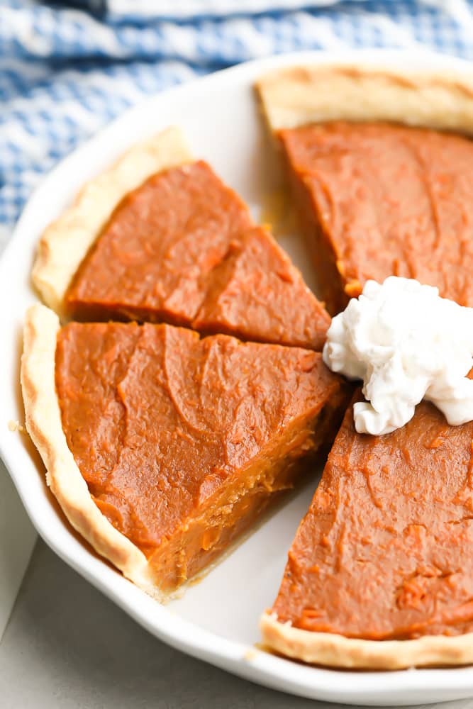 white pie dish with pie inside, cut a bit