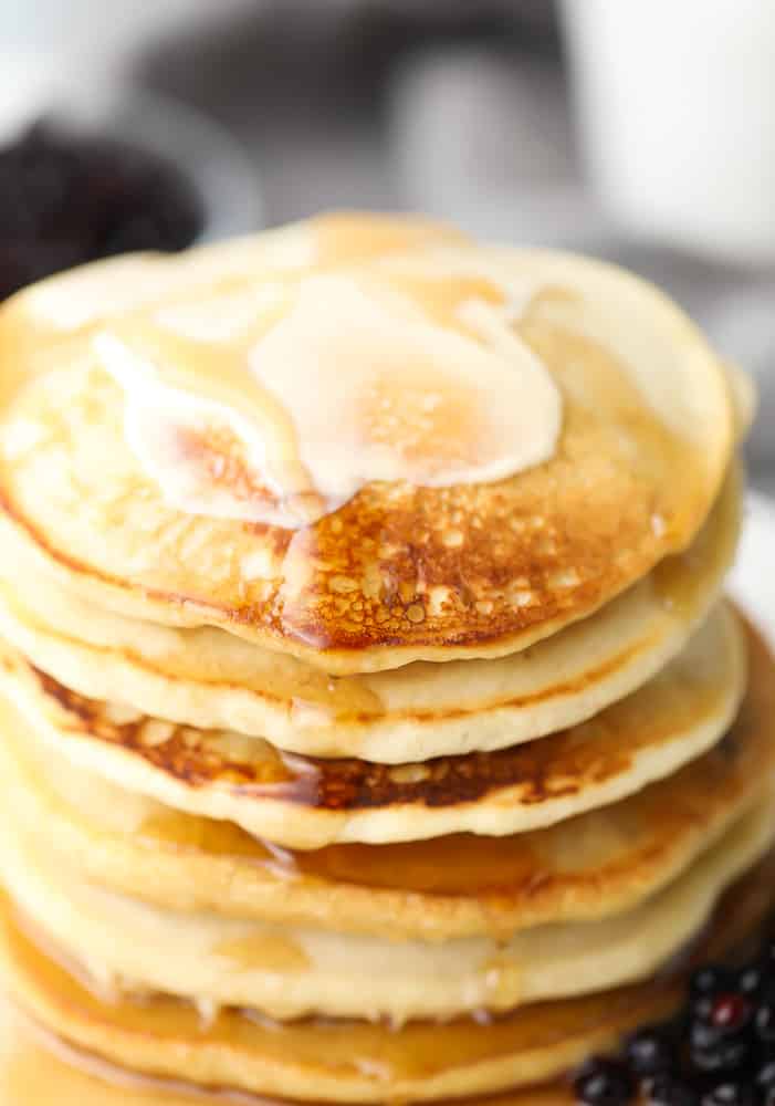 close up of stack of buckwheat pancakes with butter on them