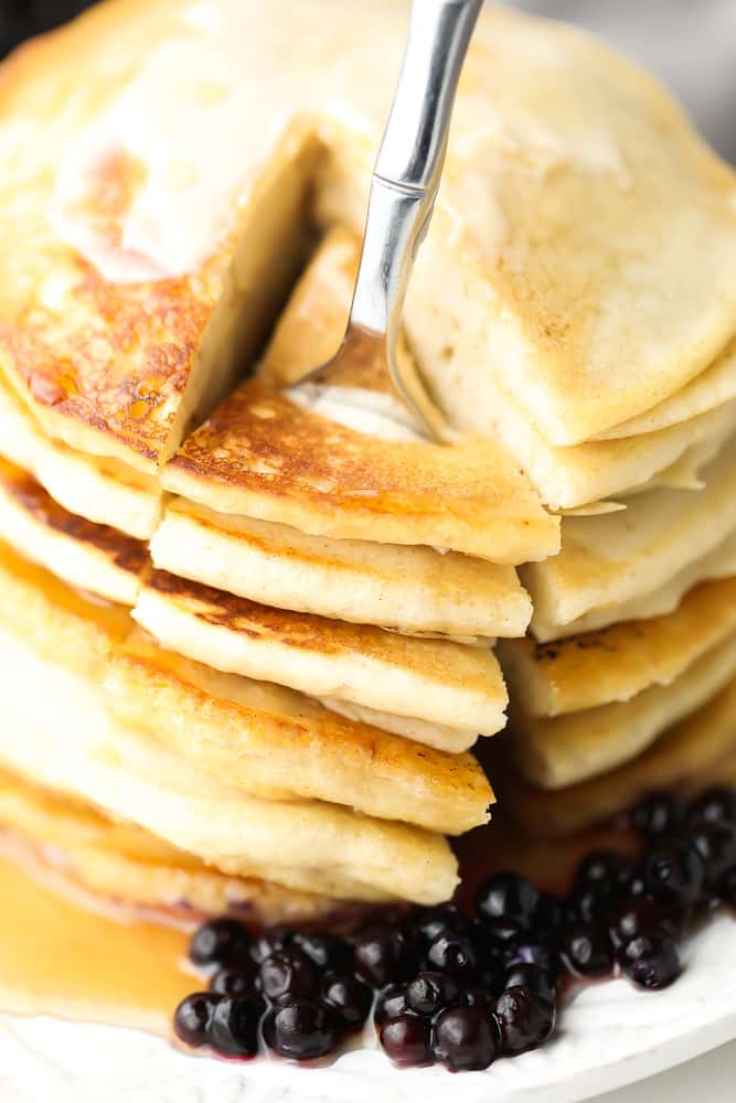 fork taking a big bite out of a pancake stack