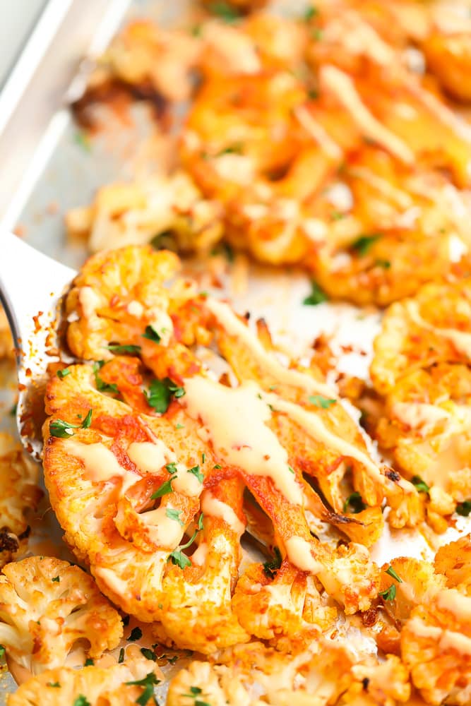 lifting up a piece of cauliflower from pan