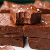 stacks of fudge with green towel in background, bite taken out of one piece