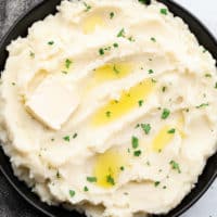 square image of mashed potatoes in black bowl