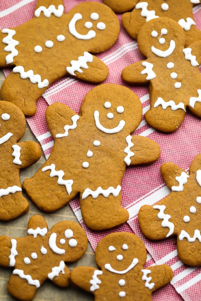 lots of iced vegan gingerbread people, with red towel in background