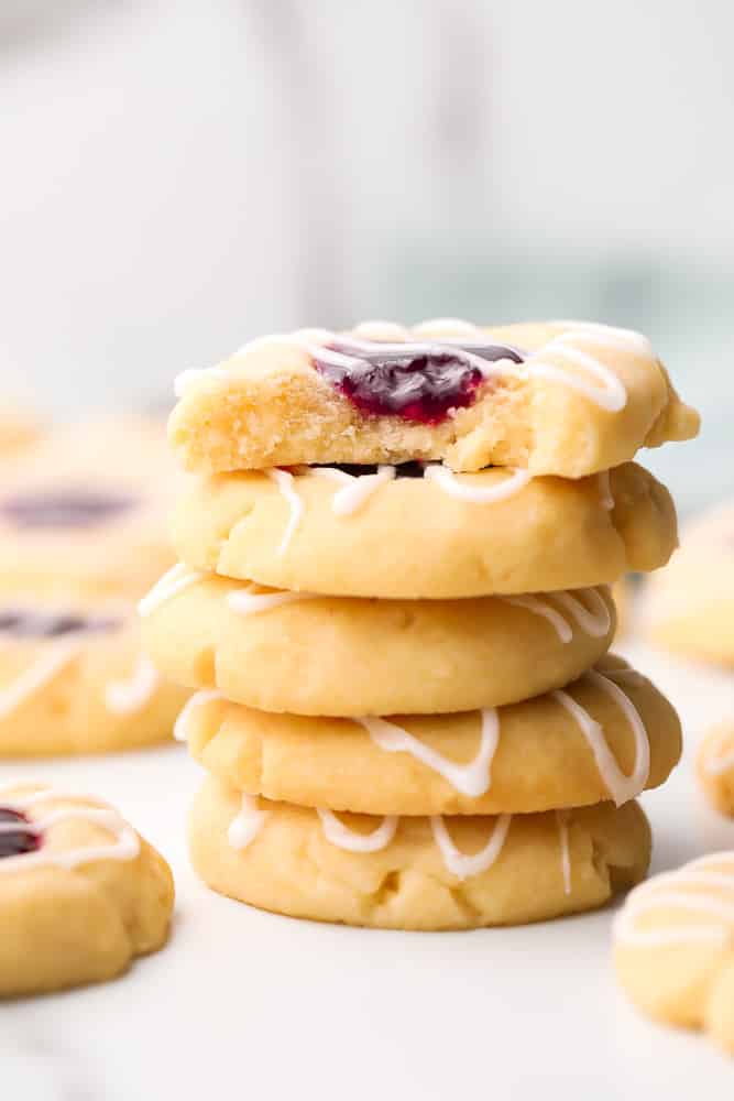 stack of cookies with red jam, marble background