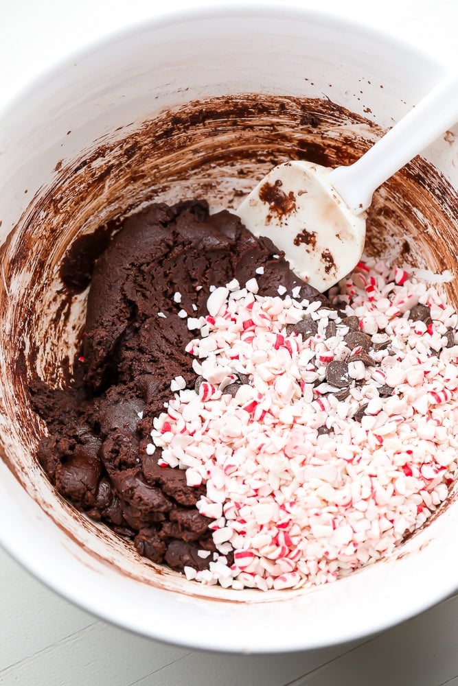 chocolate cookie dough in a bowl with candy cane pieces