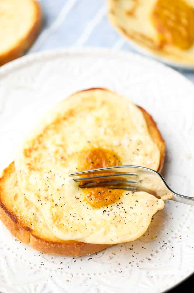 a fork cutting a vegan egg on toast