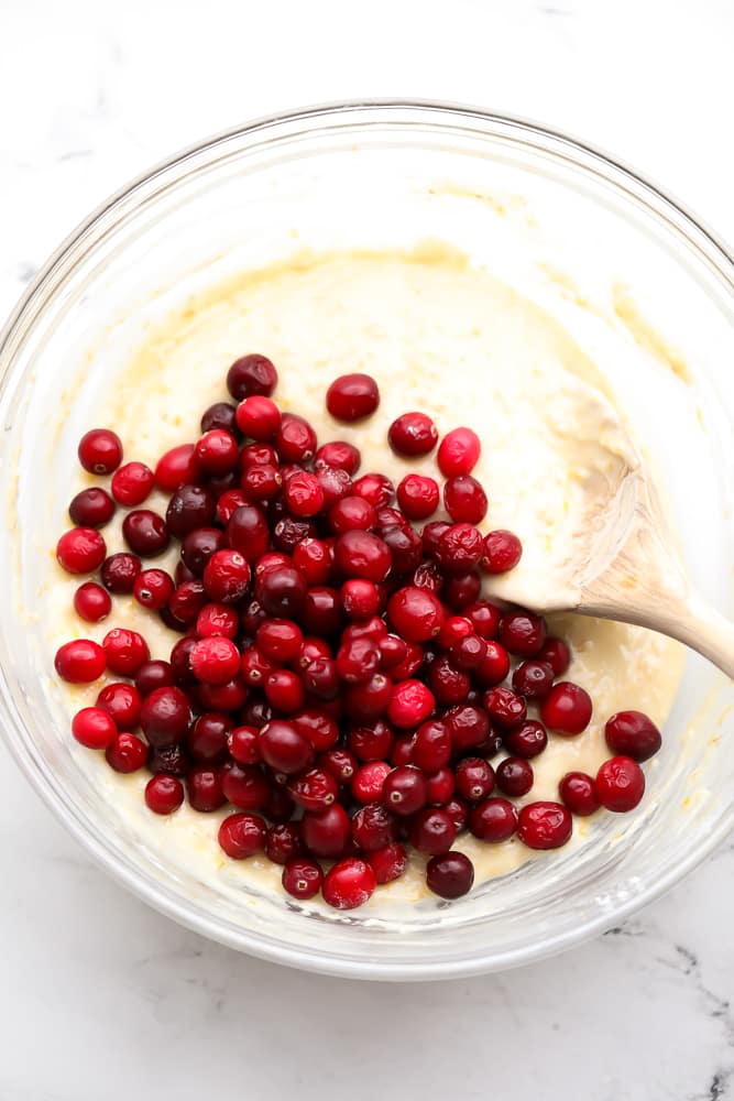 batter in a bowl with cranberries on top