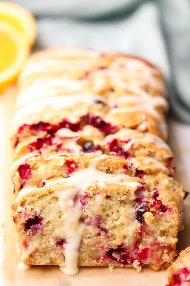 sliced orange cranberry bread with glaze