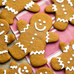 square image of gingerbread people, red towel in back.
