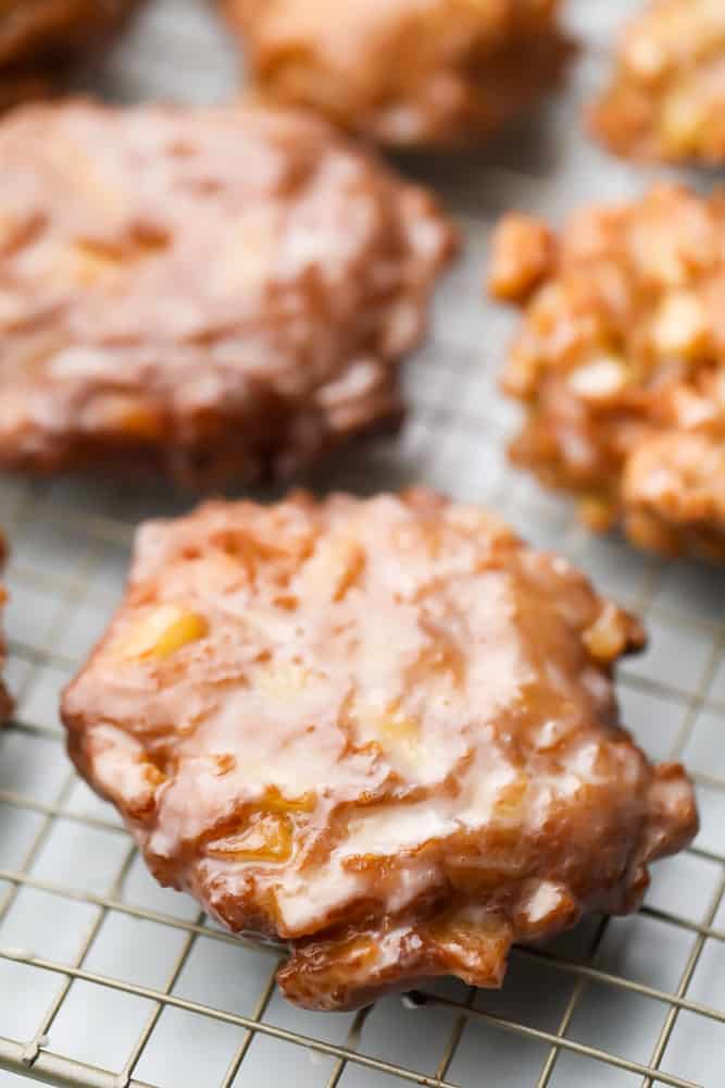 many fritter donuts on a rack