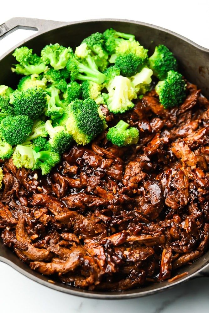 pan full of vegan beef with broccoli added in