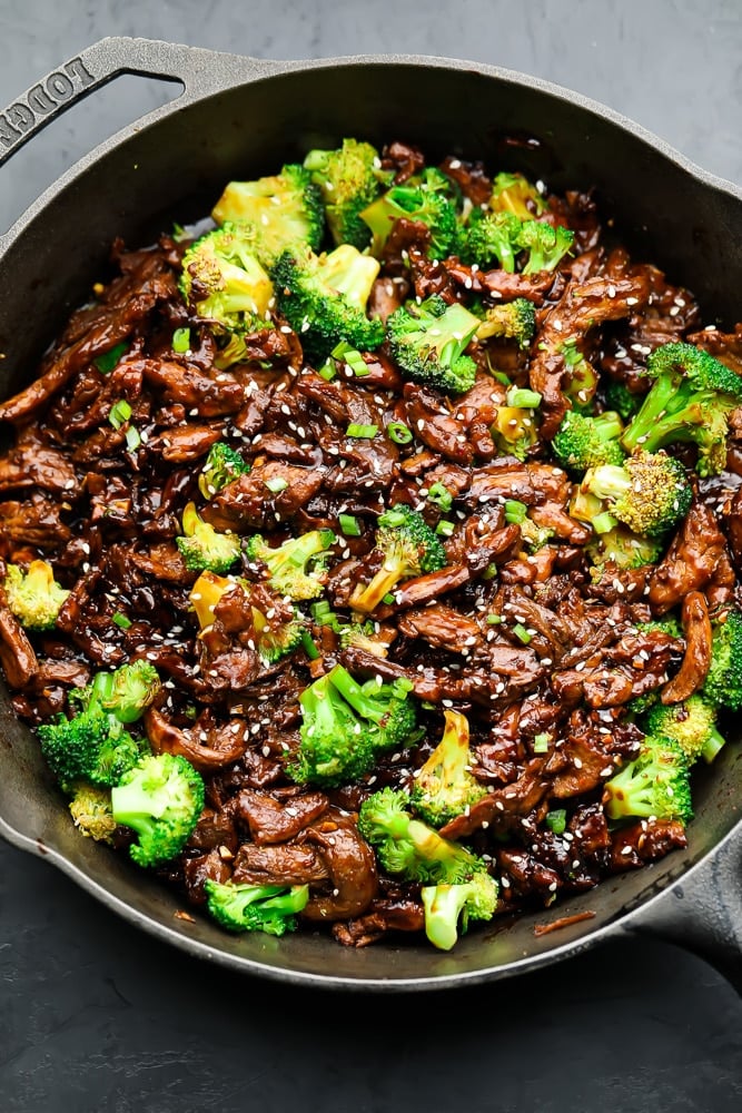 cast iron pan with what looks like meat and broccoli