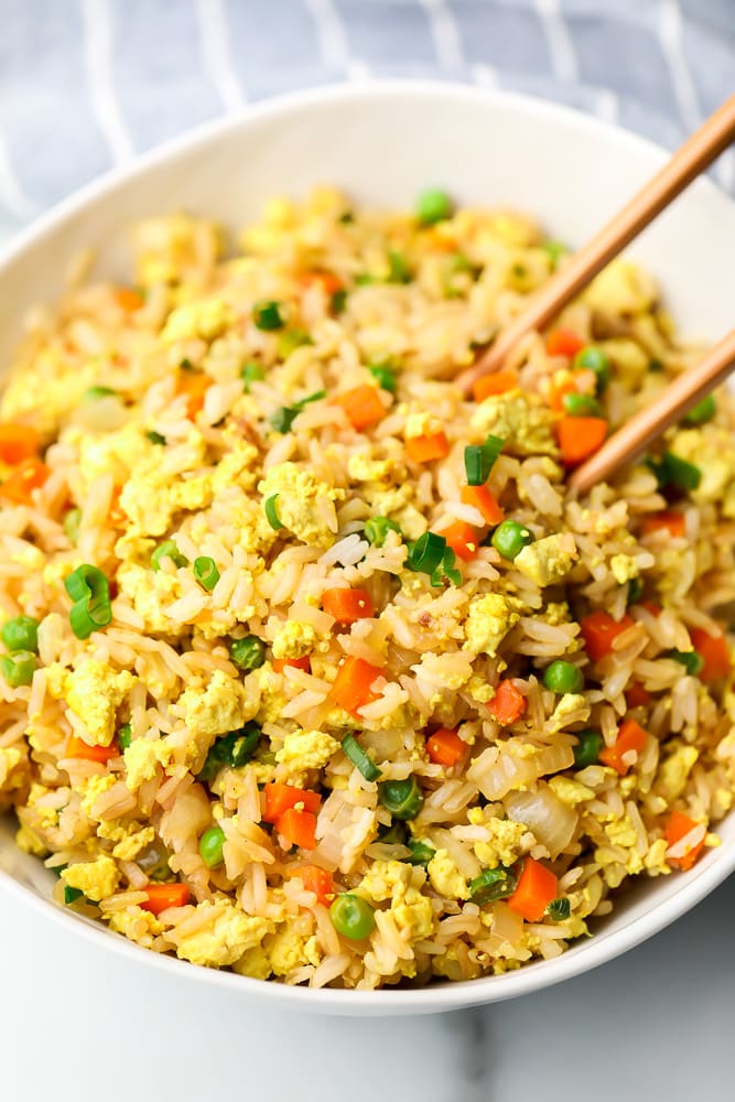 close up of a bowl of rice with chopsticks