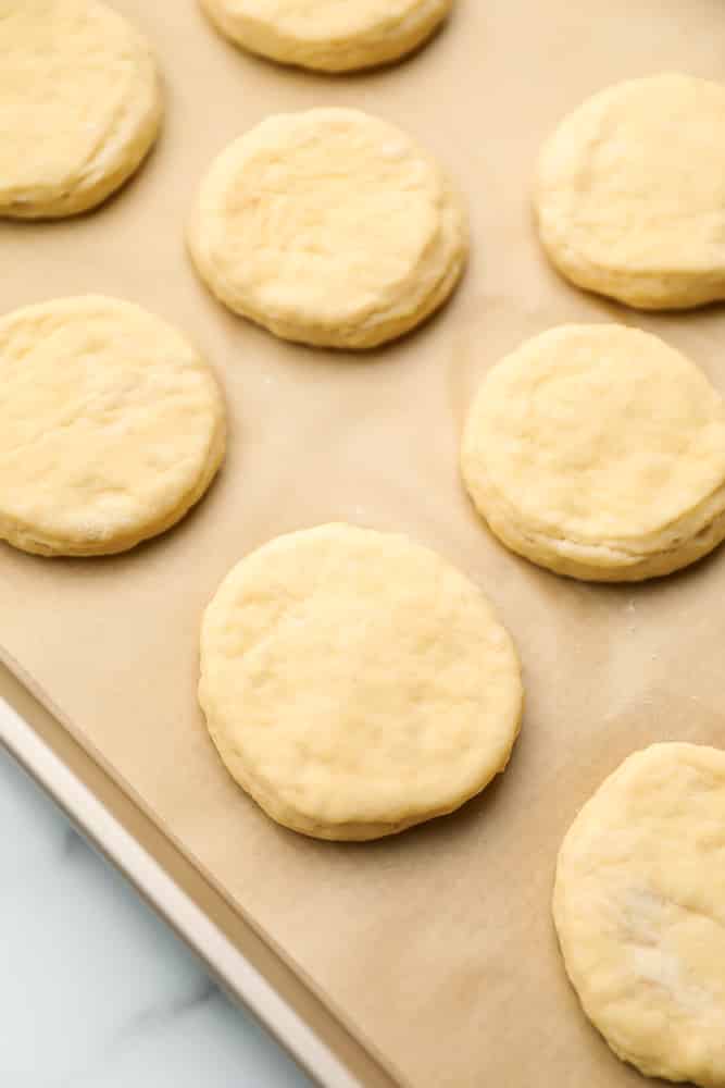 donut dough rounded on baking sheet