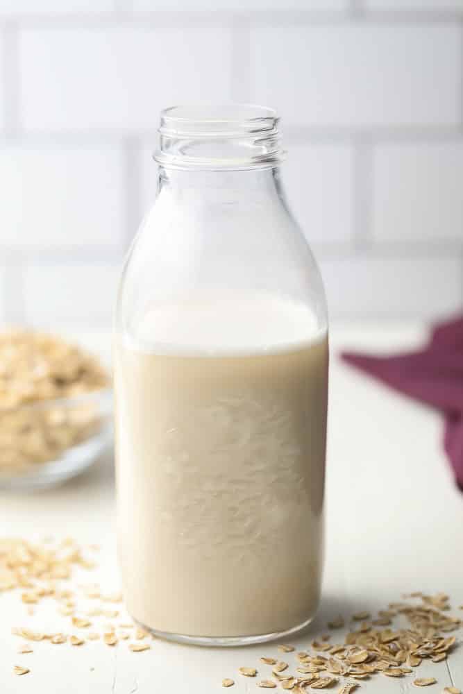 tall glass jar of oat milk