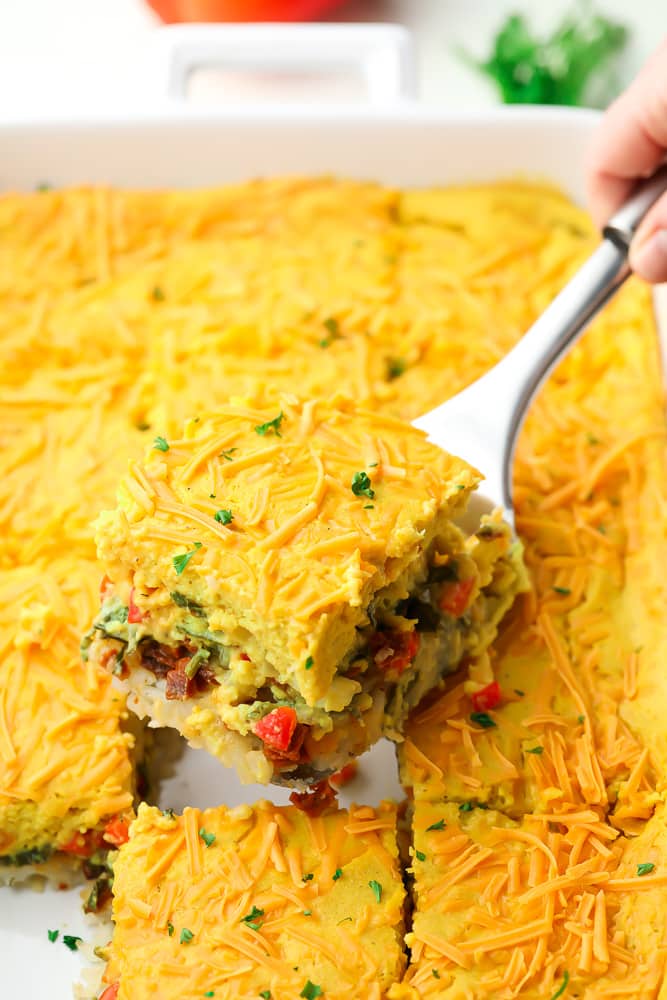 a spatula lifting a piece of casserole from dish