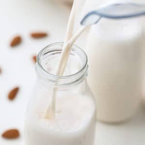 square image of milk pouring into glass