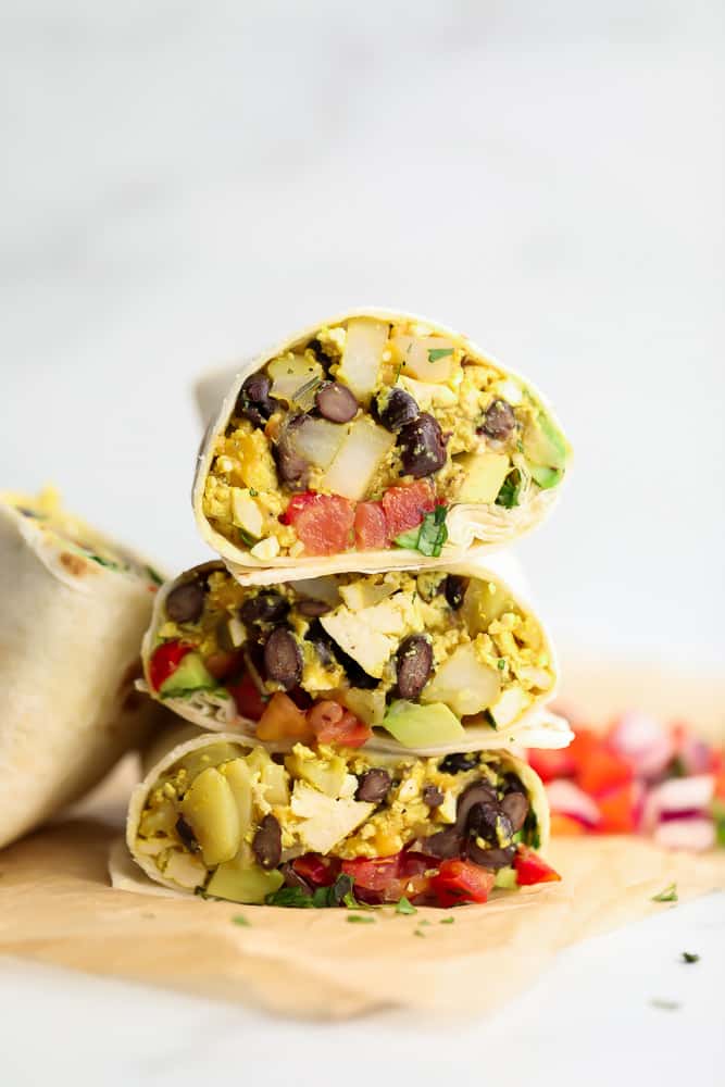 3 breakfast burritos cut in half and stacked on each other
