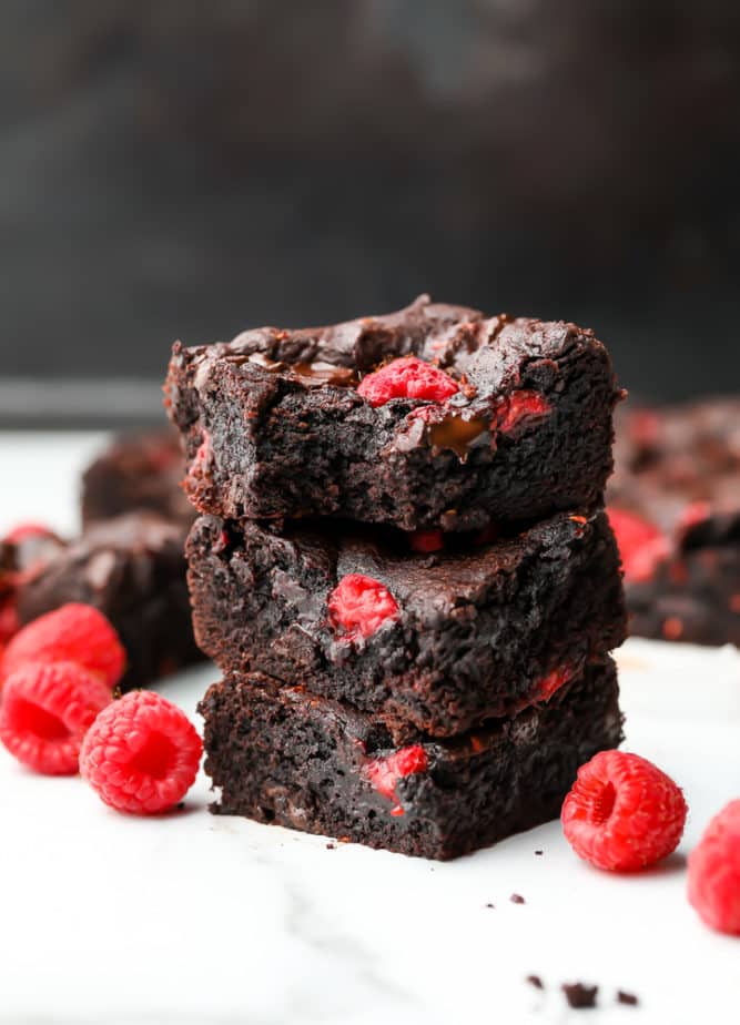 stack of 3 brownies with berries in them and around them